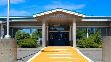 Mathxwí Elementary Exterior Image with orange crosswalk in front