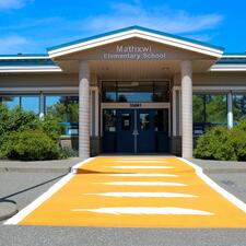 Mathxwí Elementary Exterior Image with orange crosswalk in front